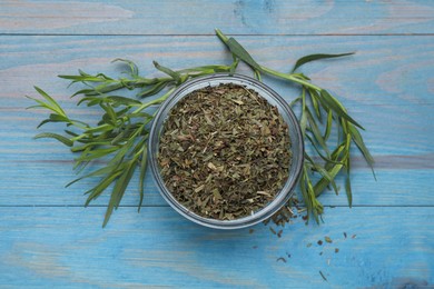 Photo of Dry and fresh tarragon on light blue wooden table, flat lay