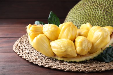 Photo of Fresh exotic jackfruit bulbs on wooden table