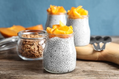 Tasty chia seed pudding with persimmon served on table