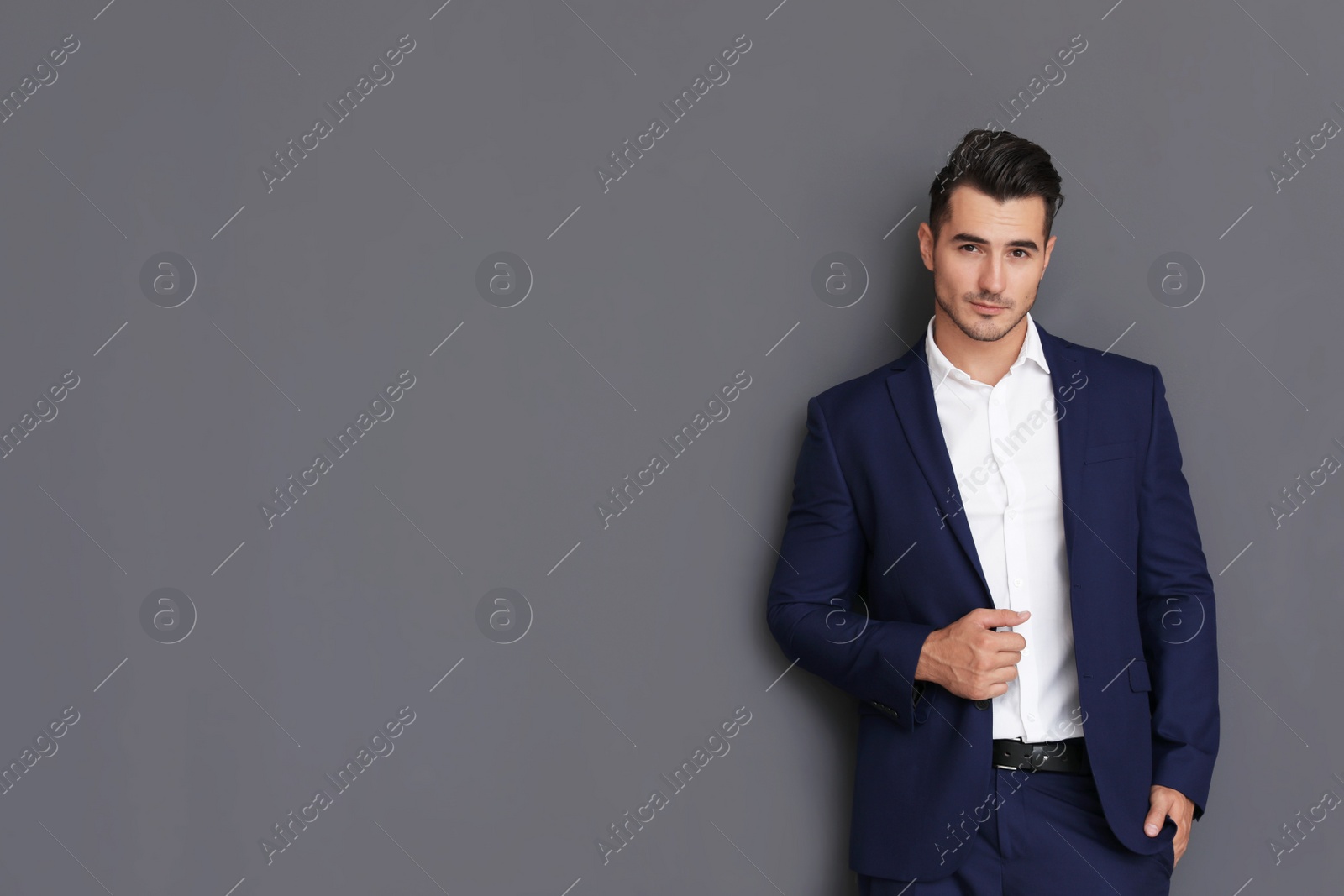 Photo of Portrait of handsome young man and space for text on grey background