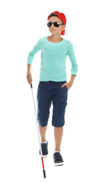 Photo of Blind boy with long cane walking on white background