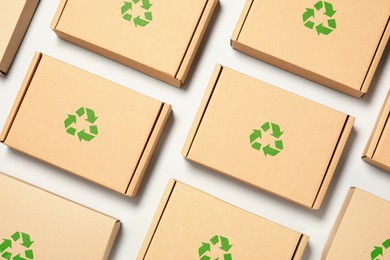 Image of Cardboard boxes with recycle sign stamps on light grey background, flat lay