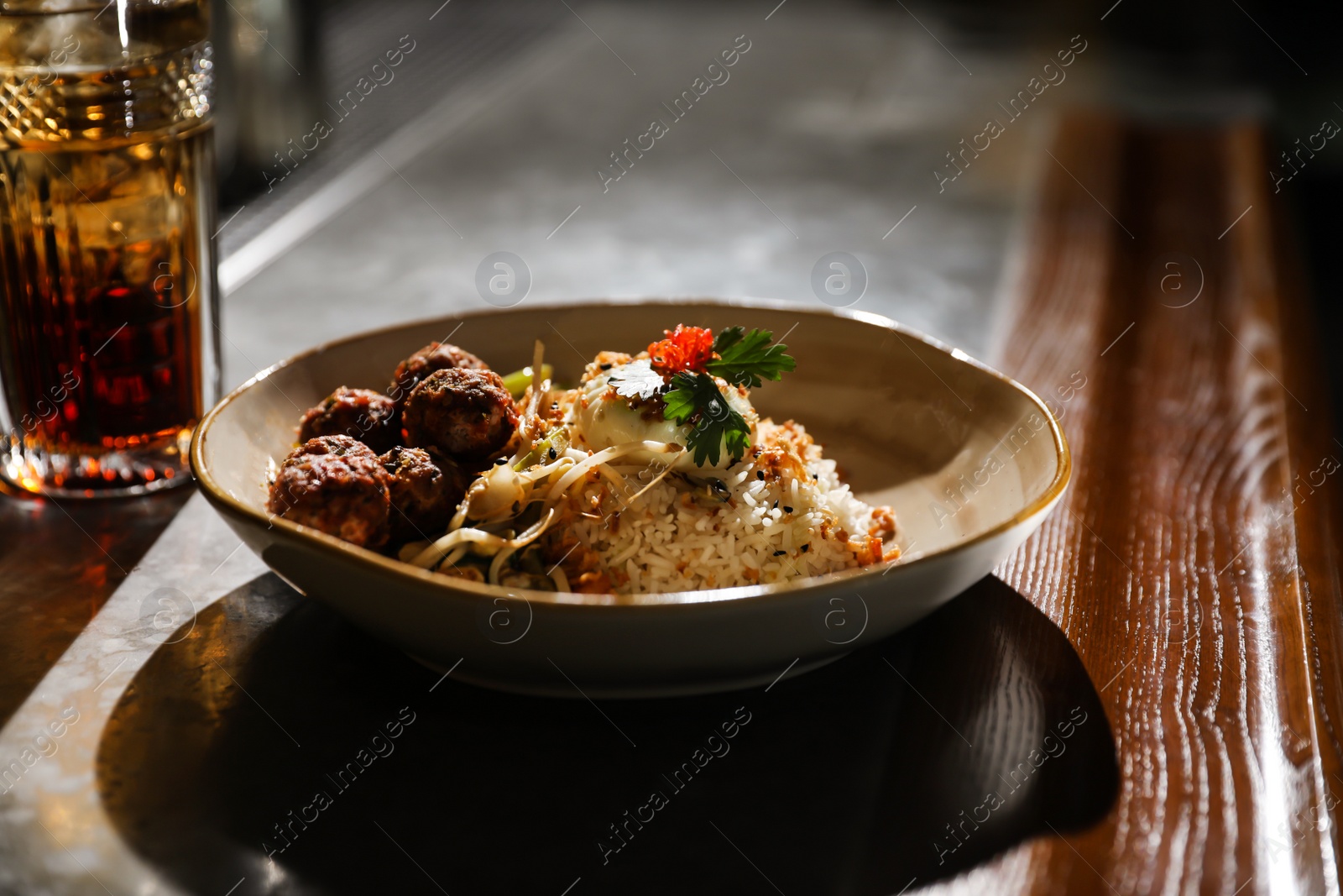 Photo of Plate with rice and meat balls served on table