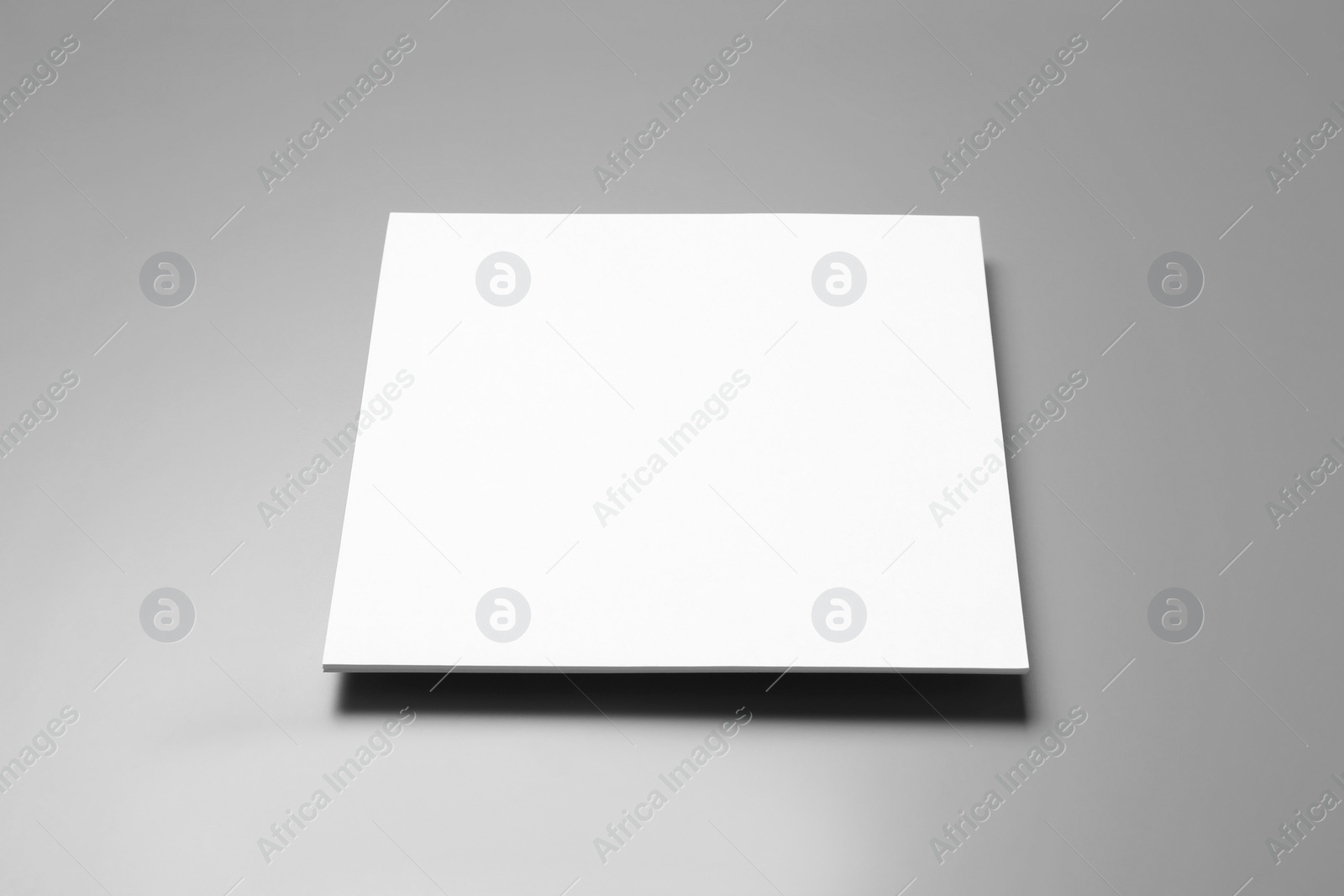 Photo of Blank paper sheets for brochure on grey background. Mock up