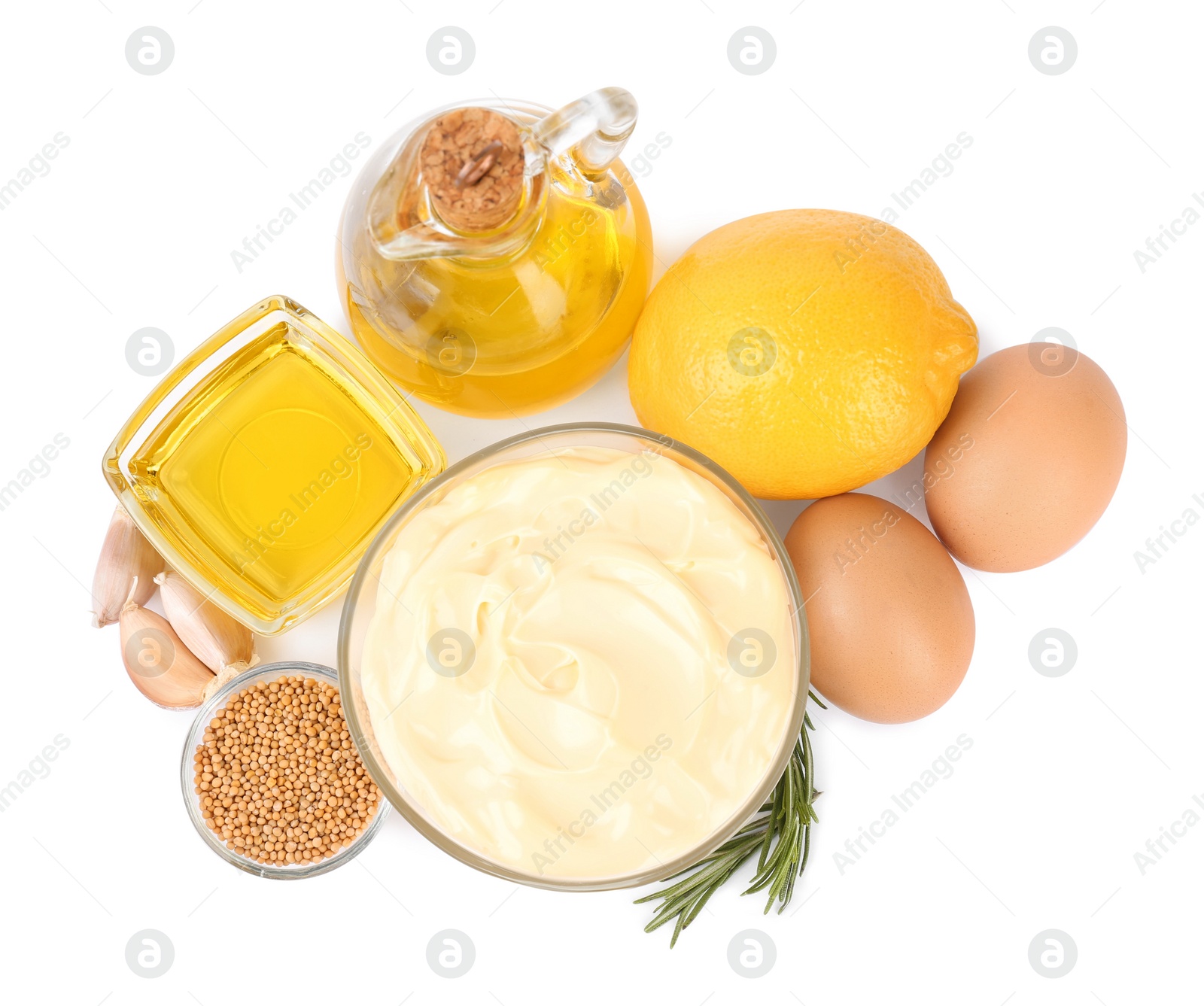 Photo of Glass bowl with fresh mayonnaise and ingredients on white background, top view