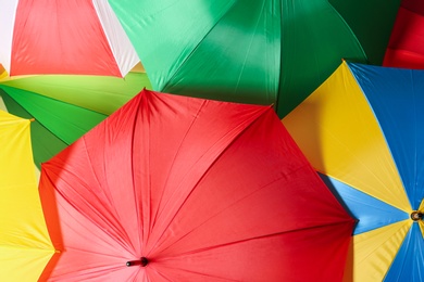 Image of Many bright umbrellas as background, top view