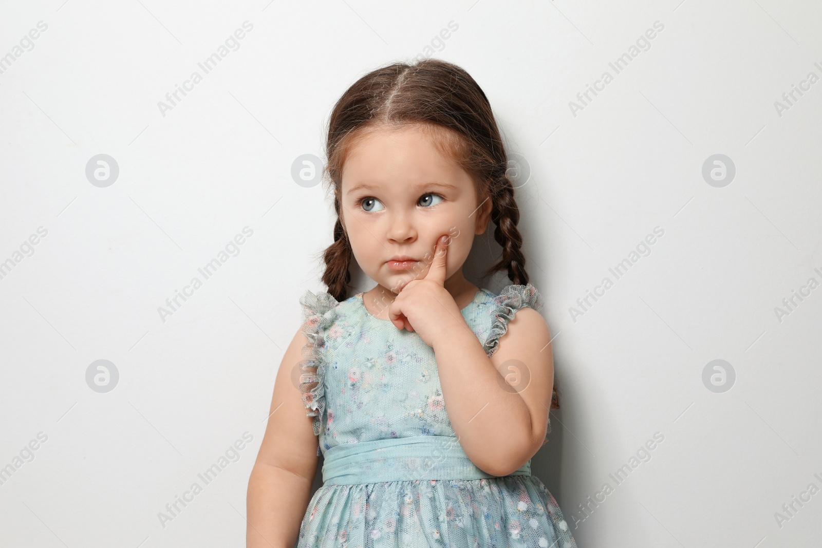 Photo of Cute little girl on light grey background