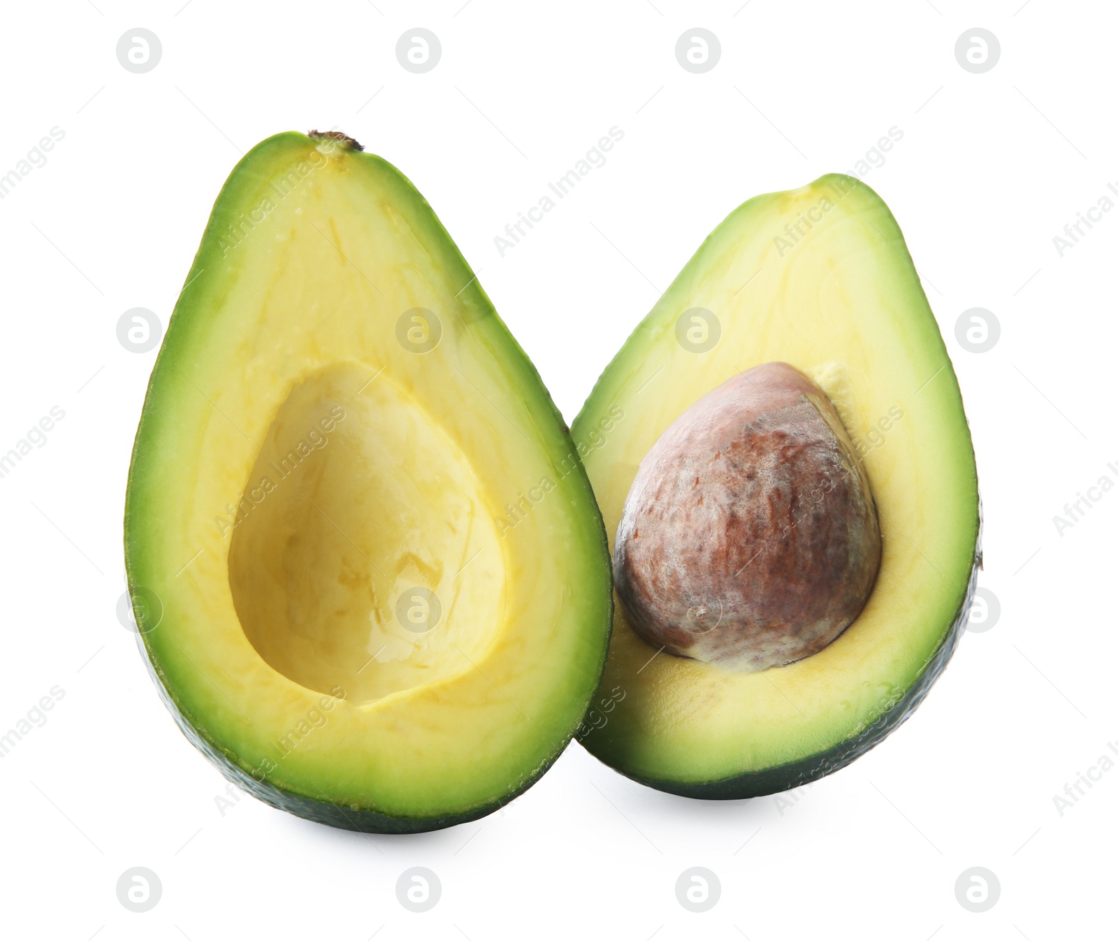 Photo of Halves of ripe avocado with pit on white background