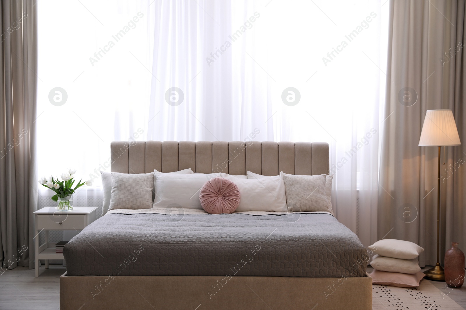 Photo of Beautiful room interior with large comfortable bed