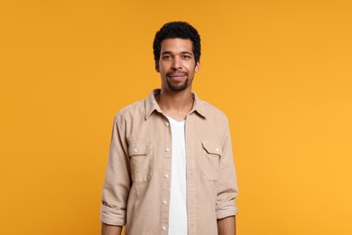 Portrait of handsome man on orange background