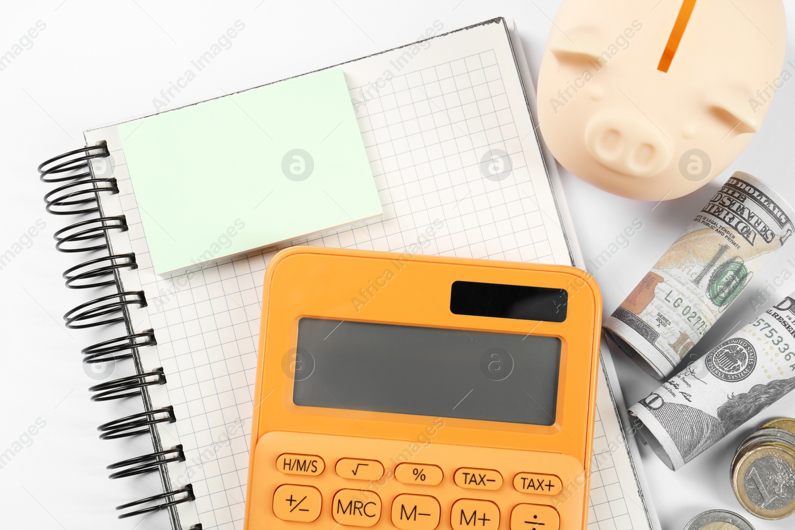 Photo of Calculator, piggy bank, sticky note and money on white background, top view. Retirement concept