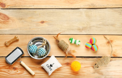 Photo of Flat lay composition with cat accessories on wooden background