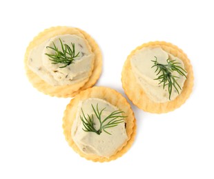 Delicious crackers with humus and dill on white background, top view