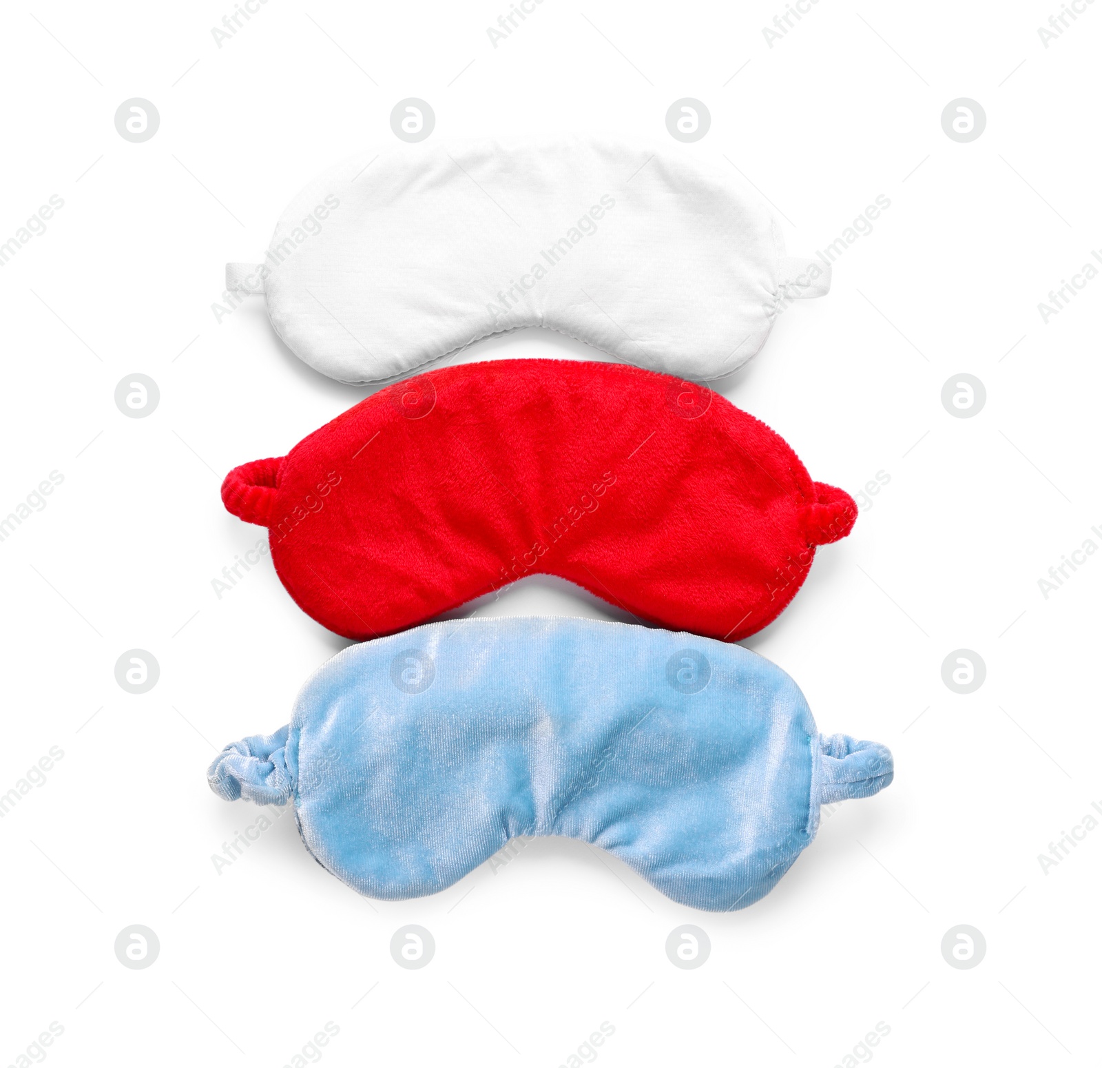 Photo of Three soft sleep masks isolated on white, top view