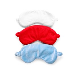 Photo of Three soft sleep masks isolated on white, top view