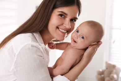 Photo of Happy young mother with her cute baby at home