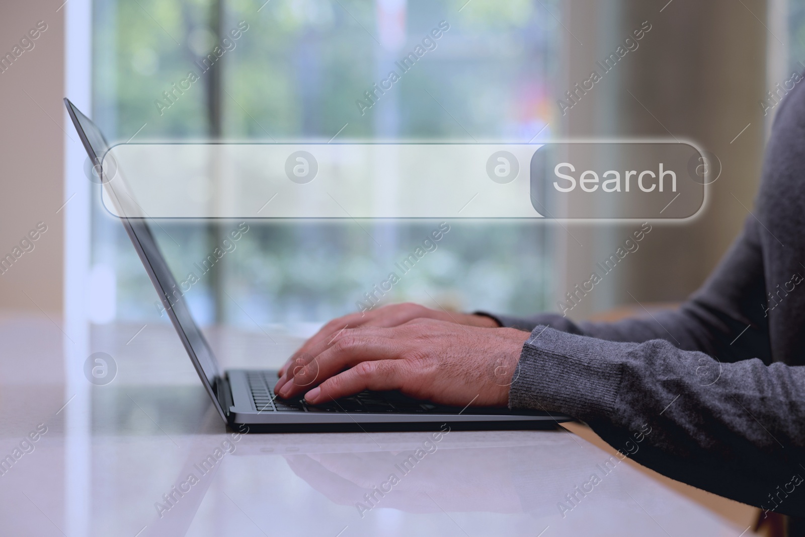Image of Search bar of website over laptop. Man using computer at table, closeup