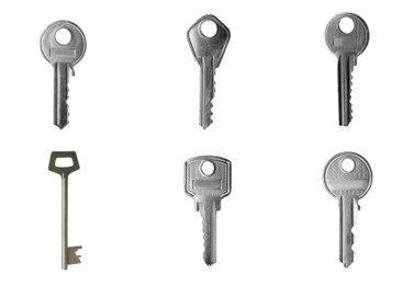 Image of Set of modern steel keys on white background