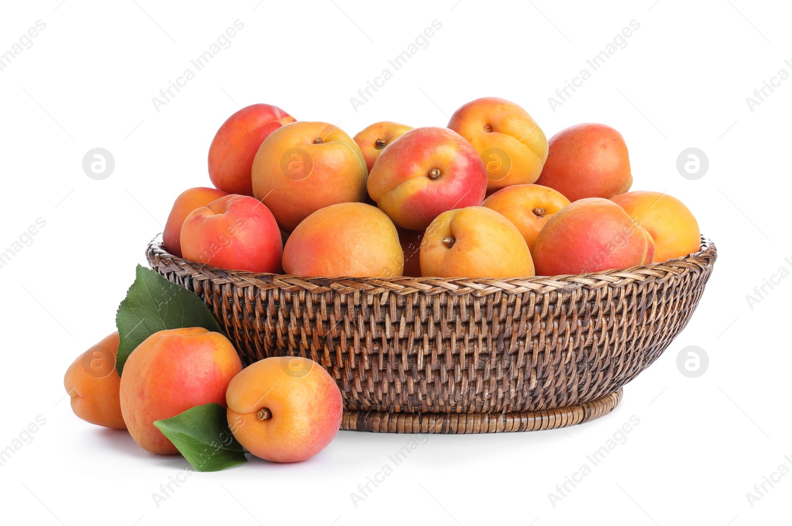 Photo of Delicious ripe apricots in wicker bowl isolated on white
