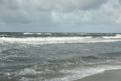 Photo of Picturesque view of wavy sea on cloudy day