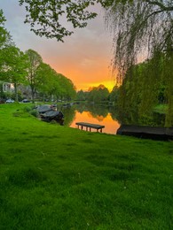 Photo of Scenic view of canal with moored boats at sunset