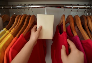 Woman putting scented sachet in wardrobe, closeup