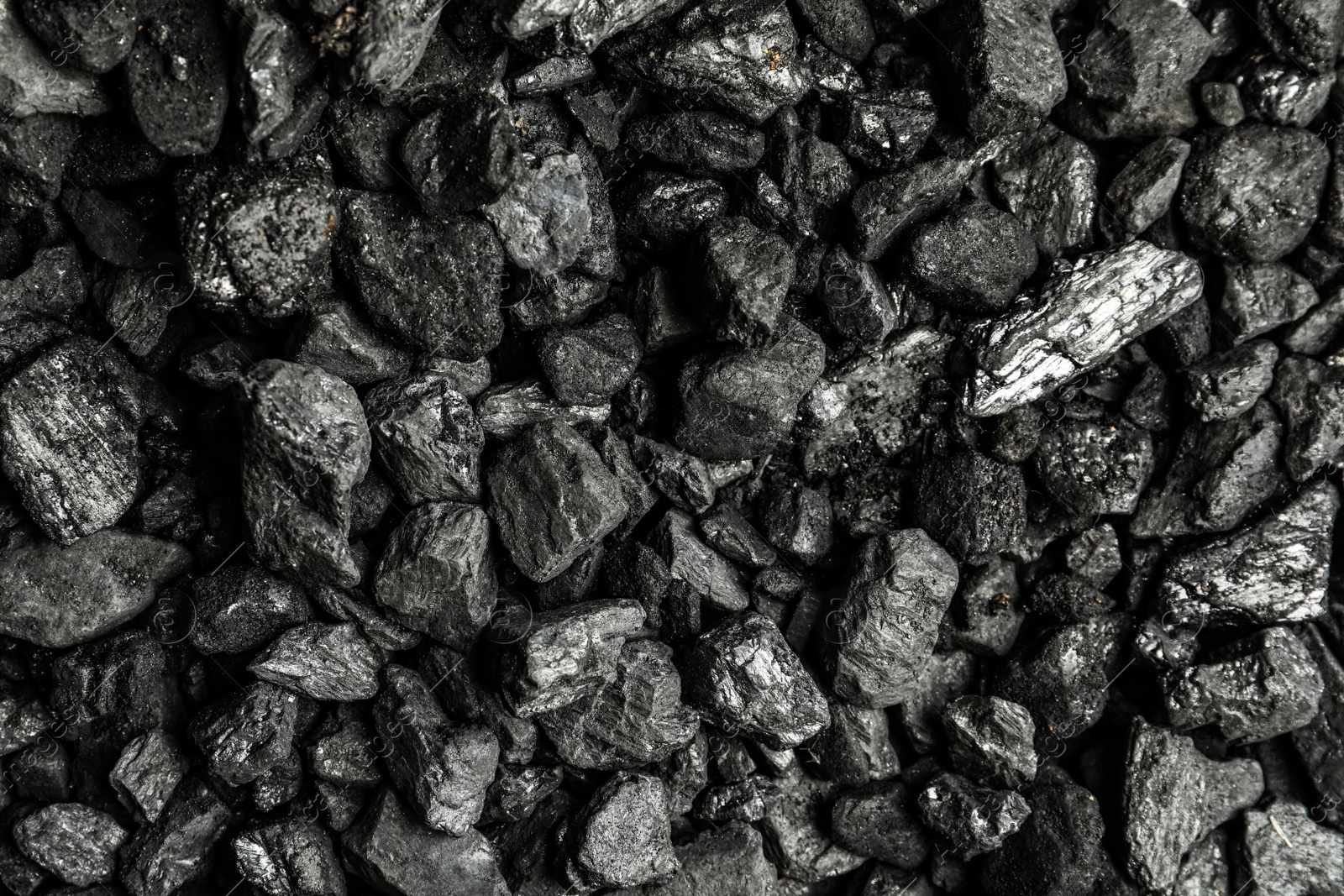 Photo of Heap of coal as background, top view