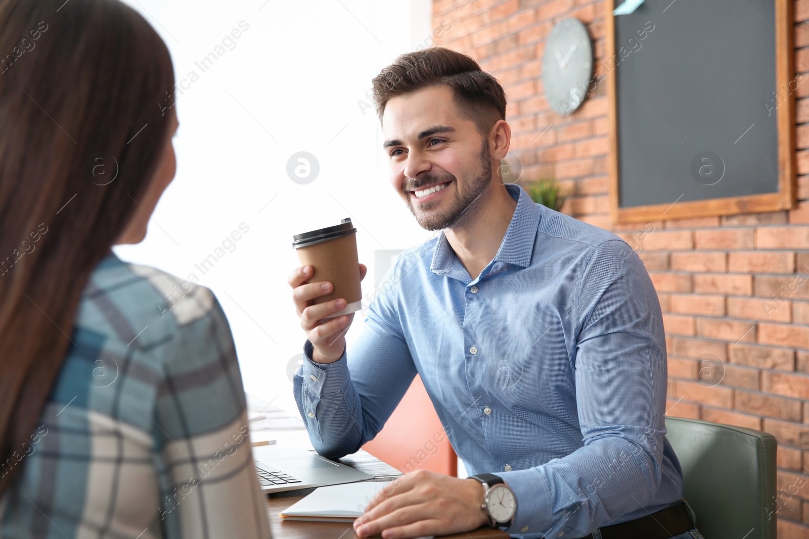 Photo of Businessman interviewing candidate in office. Professional communication