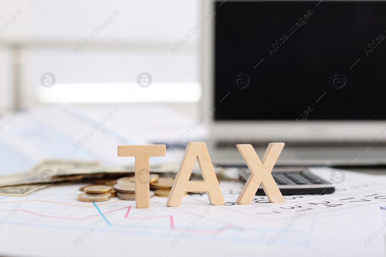 Photo of Word TAX, money and calculator on table