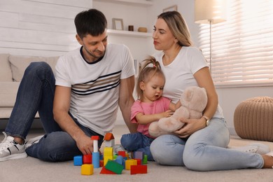 Family with little daughter spending time together at home