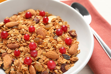 Tasty granola with cranberries on table, closeup. Healthy breakfast