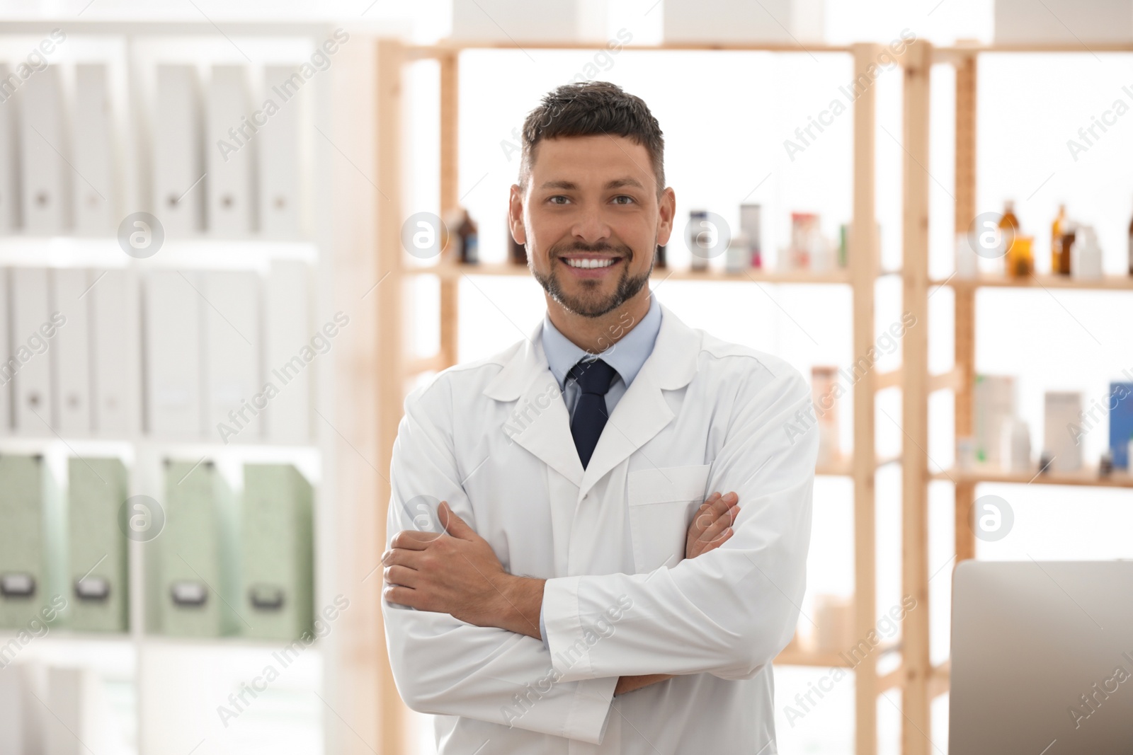 Photo of Portrait of happy male pharmacist in drugstore