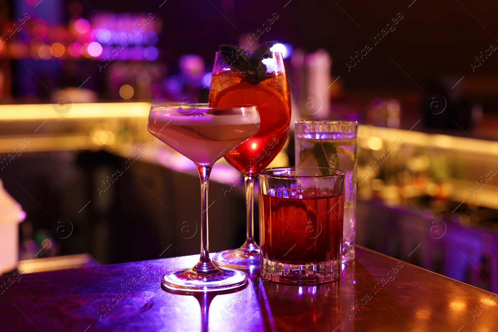 Photo of Fresh alcoholic cocktails on counter in bar