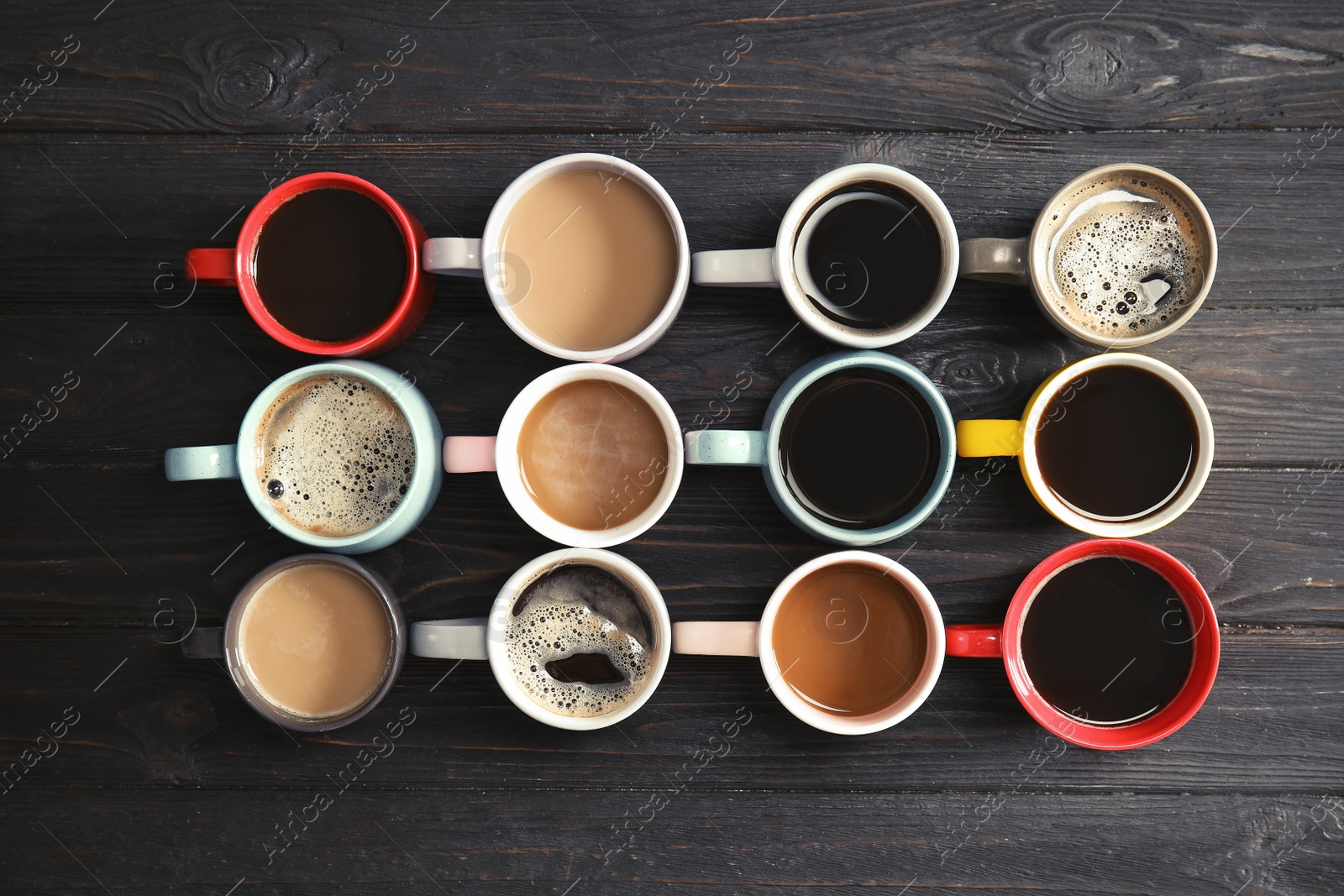 Photo of Flat lay composition with cups of coffee on wooden background. Food photography