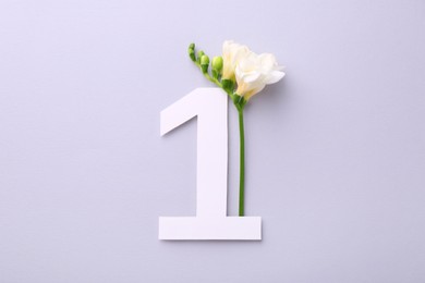 Photo of Paper number 1 and beautiful flower on light grey background, top view