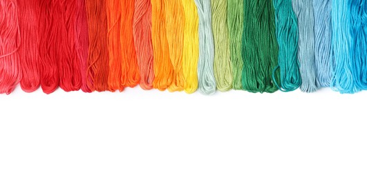 Set of colorful embroidery threads on white background, top view