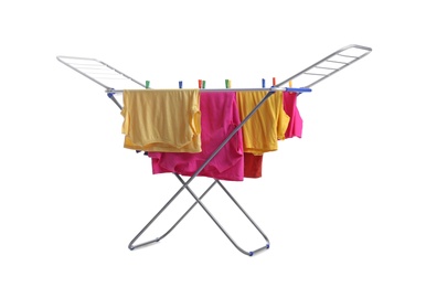 Clean laundry hanging on drying rack against white background