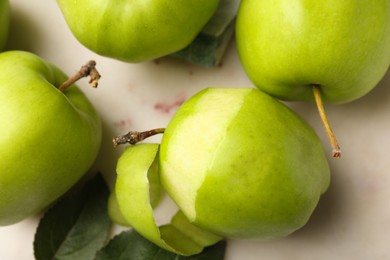 Ripe green apples on beige table, flat lay
