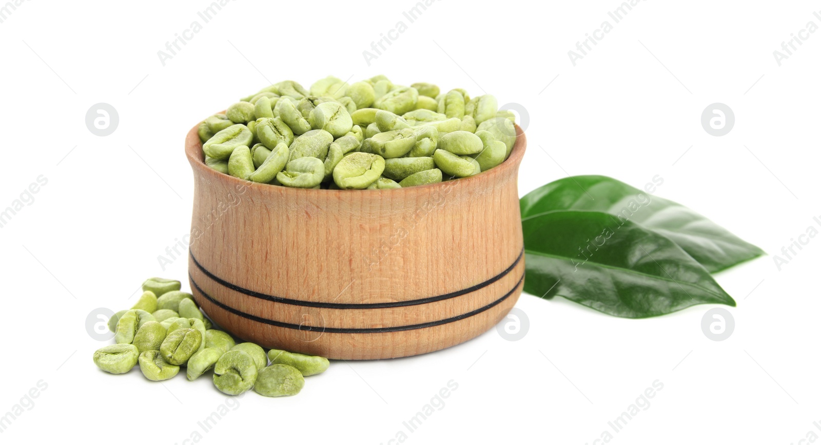 Photo of Wooden bowl with green coffee beans and fresh leaves on white background