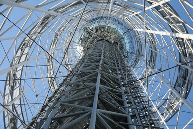 Photo of Structure of modern tower against blue sky, bottom view