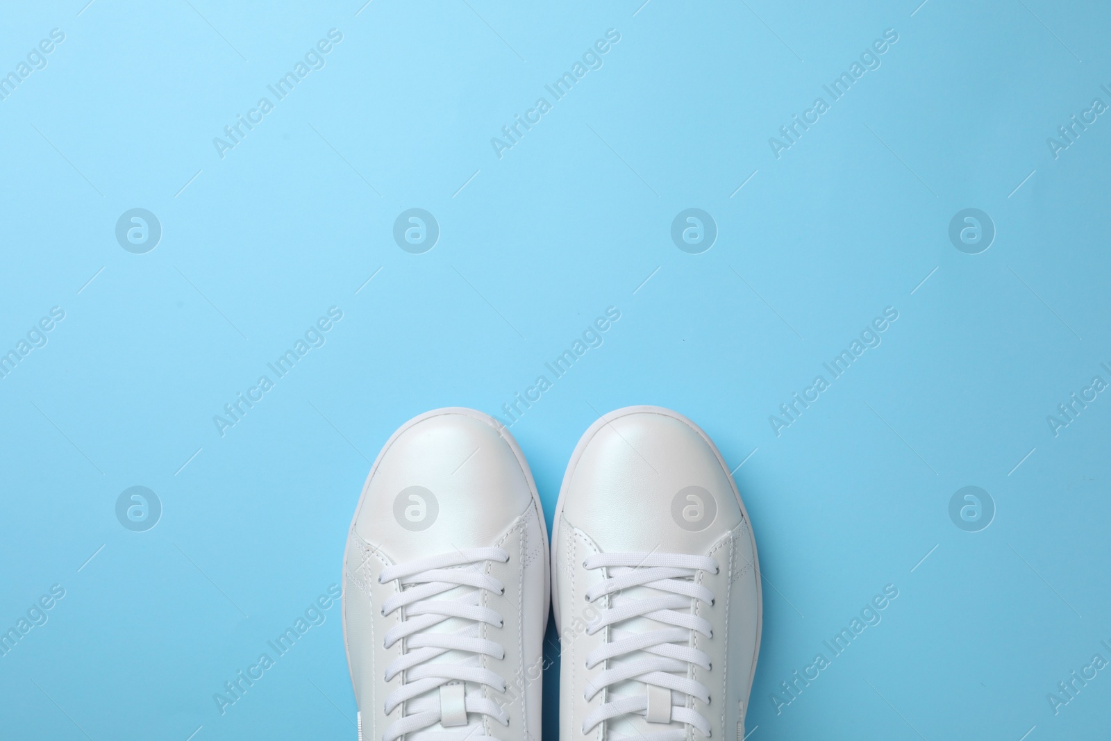 Photo of Pair of sneakers on color background, flat lay. Space for text