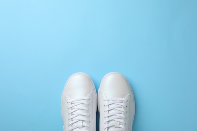 Photo of Pair of sneakers on color background, flat lay. Space for text