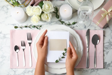 Photo of Woman setting table for festive dinner, top view