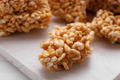 Puffed rice bars (kozinaki) on white table, closeup