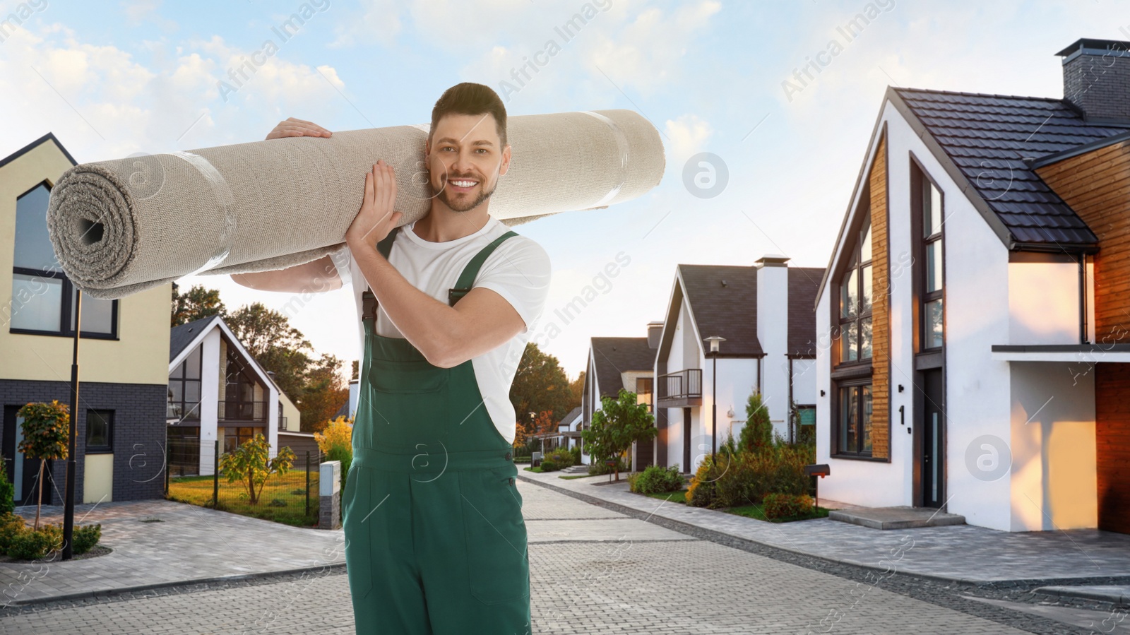 Image of Worker with rolled carpet outdoors on sunny day. Banner design