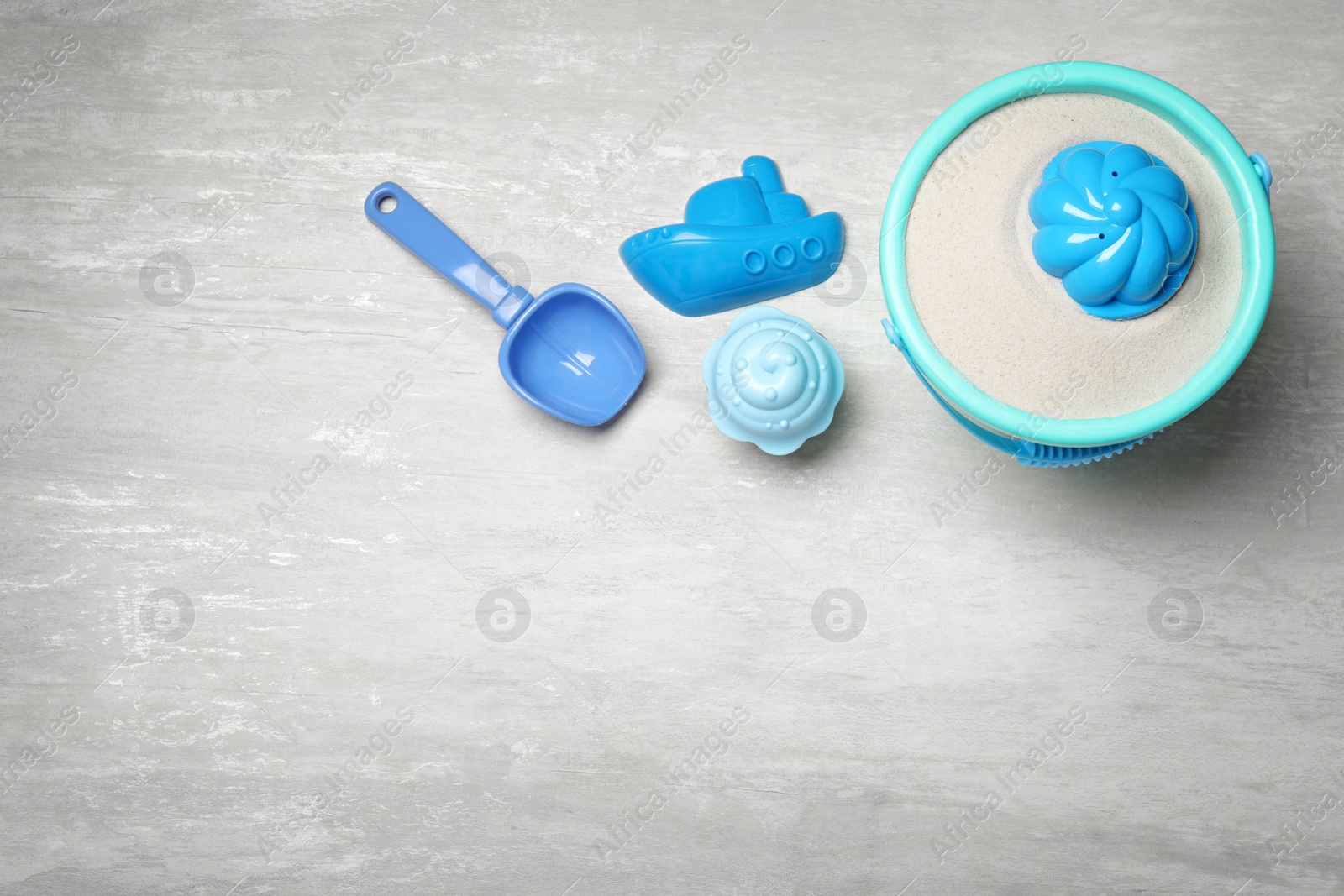 Photo of Flat lay composition with beach toys on light background. Space for text