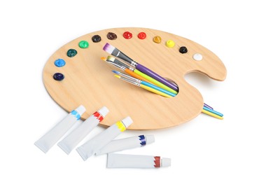 Photo of Palette with acrylic paints and brushes on white background. Artist equipment