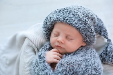 Photo of Cute newborn baby sleeping on plaid, top view