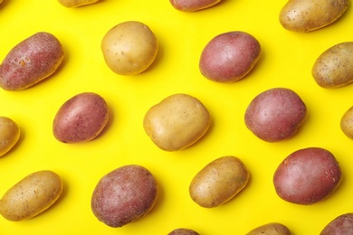 Flat lay composition with fresh organic potatoes on color background