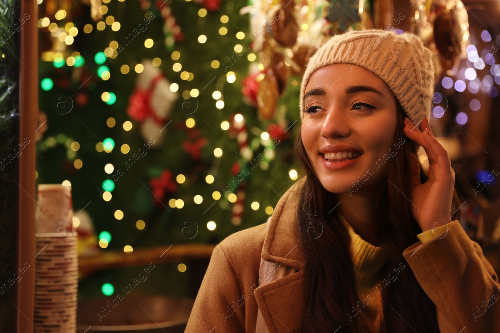 Photo of Young woman spending time at Christmas fair